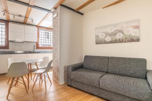 a living room with a couch and a table at Basilica Prestige Residence, lusso e comfort in Vicenza +4 photos