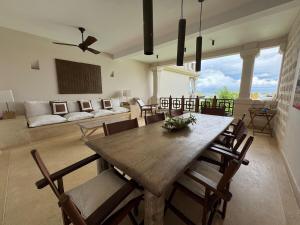 a living room with a wooden table and chairs at Casa Sanaa - Sea view in Watamu