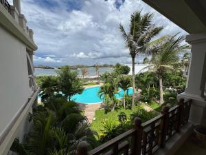 a view of the pool from the balcony of a resort at Casa Sanaa - Sea view in Watamu
