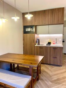 a kitchen with a wooden table and a counter at Appartement terrasse centre Saint Martin in Saint-Martin-de-Ré +3 photos
