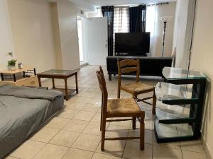 a living room with a bed and a glass table at New Jersey Apt 1 bd in Edison