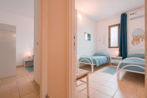 une chambre avec un lit, une table et des chaises dans l'établissement Giobo Mare, à La Caletta