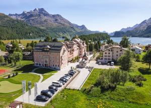 an aerial view of a town with cars parked in front of a building at Parkhotel Margna Superior in Sils Maria