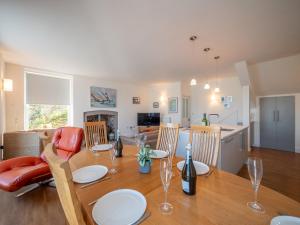 a dining room and kitchen with a table and chairs at Riverside Apartment with Stunning Views & Patio in Dartmouth