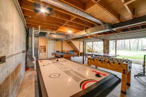 a large room with a ping pong table in it at Game Room and Decks Family Cabin in Springville! in Springville