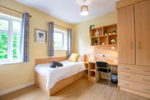 a bedroom with a bed and a desk and a desk at 133 - Large Duplex House by Shortstays in Galway