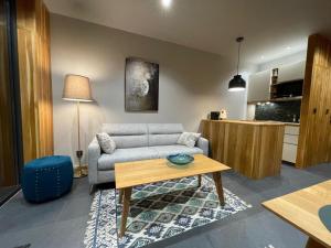 a living room with a couch and a table at Naturalna Cisza in Michałkowa