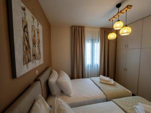 a hotel room with two beds and two lamps at THETIS Luxury House in Nikiti
