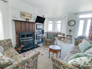 a living room with couches and a fireplace at The Harbour in Rhosneigr
