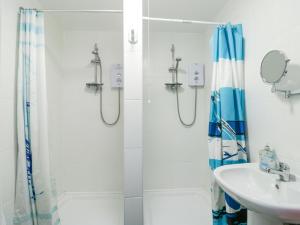 a bathroom with a shower and a sink at The Harbour in Rhosneigr +28 photos