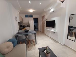 a living room and kitchen with a table and a couch at S & D apartment in Heraklio Town