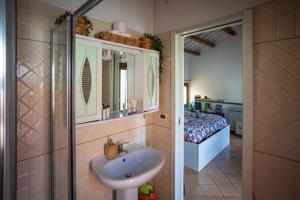 a bathroom with a sink and a shower and a bed at Bloom and Wood in Padova +36 photos