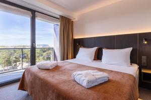 a hotel room with a large bed with a large window at Jurmala Spa Hotel in Jūrmala +66 photos