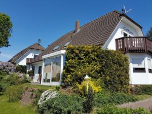 a white house with a brown roof at Ferienwohnung-3-im-Haus-Baltique in Glowe