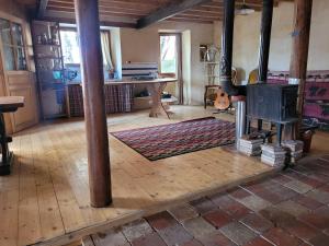 a living room with a table and a stove at Terre Rouge in Boulc