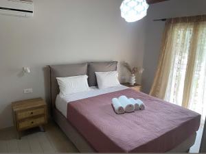 a bedroom with a bed with two towels on it at SPITI MAGDALINI in Agios Georgios Pagon