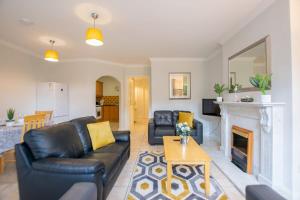 a living room with a couch and a fireplace at 32 -Spacious 2BR Galway stay - Sleeps 6 in Galway +31 photos