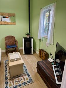 a living room with a couch and a table at Rose's Cottage Foz in Foz do Arelho