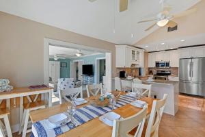 a kitchen and dining room with a table and chairs at Casa Palmera by SkyRun Anna Maria in Bradenton