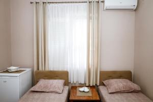 Postel nebo postele na pokoji v ubytování Apartments Djukic