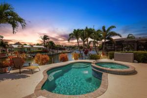 a swimming pool in the middle of a resort at Casa Palmera by SkyRun Anna Maria in Bradenton