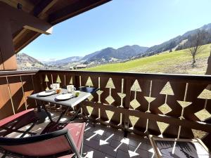 a patio with a table and chairs on a balcony at Appartement 2 pièces à Praz Sur Arly, parking, proche pistes, pour 5 personnes - FR-1-603-68 in Praz-sur-Arly