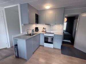 a kitchen with white cabinets and a sink at New Small house Uppsala in Uppsala