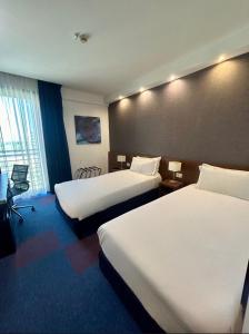 Posteľ alebo postele v izbe v ubytovaní GP Hotel