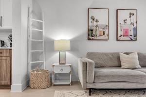 a living room with a gray couch and a lamp at Vibrant 1 Bedroom Paradise Pool and Gym Bliss in Apollo Beach