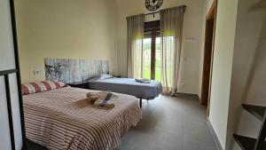 a bedroom with two beds and a clock on the wall at Mi Casa en Guriezo in Angostina