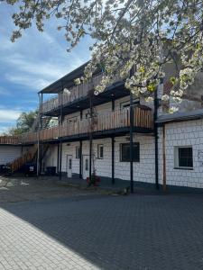 a building with a deck on the side of it at Unseburger Brauhaus GmbH Ferienwohnung 3 in Unseburg