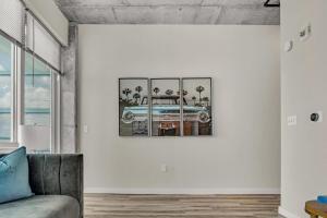 a living room with a picture of a car on the wall at Live the Downtown Life Cozy 1 Bed Near Tropicana in St Petersburg