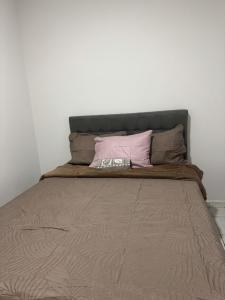 a bed with two pillows on top of it at Flat mobiliado in Arapiraca