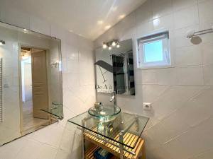 a bathroom with a glass sink and a mirror at La Petite Cèpe - Au bord de la plage et de la forêt in La Tremblade +43 photos