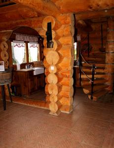a bathroom in a log cabin with a sink at Gite En Rondins in Janvry