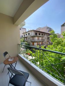 a balcony with a chair and a table and a view at HERA QUEEN Boutique in Larisa