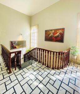 a room with stairs and a painting on the wall at 3 BDR F10-1 Escape in Islamabad