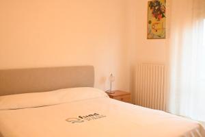 a bedroom with a bed with a white bedspread at SE148 - Marotta, trilocale con terrazzo e posto auto in Marotta