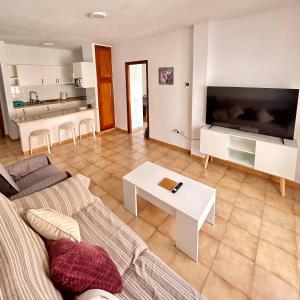 a living room with a couch and a table at Apt In Colina 2, Los Cristianos K105 in El Guincho +10 photos