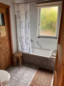 a bathroom with a tub and a toilet and a window at Ferienhaus Vita in Extertal +19 photos