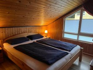 a bedroom with a large bed in a wooden room at Ferienhaus Vita in Extertal