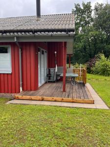 a wooden deck with a bench and a table on a house at Ferienhaus Vita in Extertal