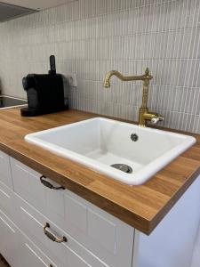 a white sink in a kitchen with a counter at Ferienhaus Unter der Burg in Gerolstein +18 photos