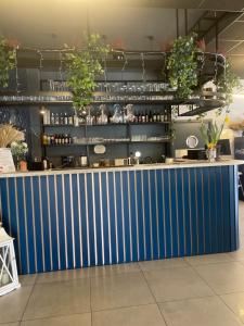 a blue counter in a room with plants at Arkadia in Podgajek