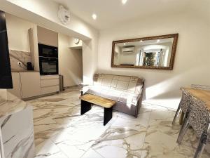 a living room with a couch and a mirror at U TIGRU - Luxe au cœur d'un village du Cap Corse in Luri