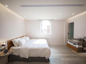 Postel nebo postele na pokoji v ubytování LIVIN Hotel