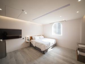 Postel nebo postele na pokoji v ubytování LIVIN Hotel