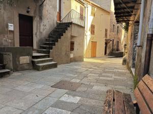 an alley with stairs and a bench in a building at U TIGRU - Luxe au cœur d'un village du Cap Corse in Luri