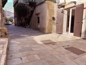 an alley with an open door on a building at U TIGRU - Luxe au cœur d'un village du Cap Corse in Luri +23 photos