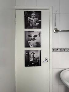 a bathroom with a door with pictures on it at London Studio in London